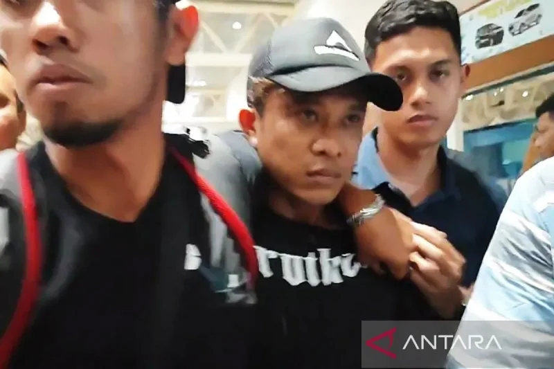 Tersangka ANT pembunuhan dan pengecoran pegawai koperasi di Palembang saat digiring kepolisian di Bandara SMB II Palembang, Sumatera Selatan, Sabtu (29/6/2024). ANTARA/M Imam Pramana/aa.
